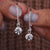 Round diamond earrings with dangle setting style.
