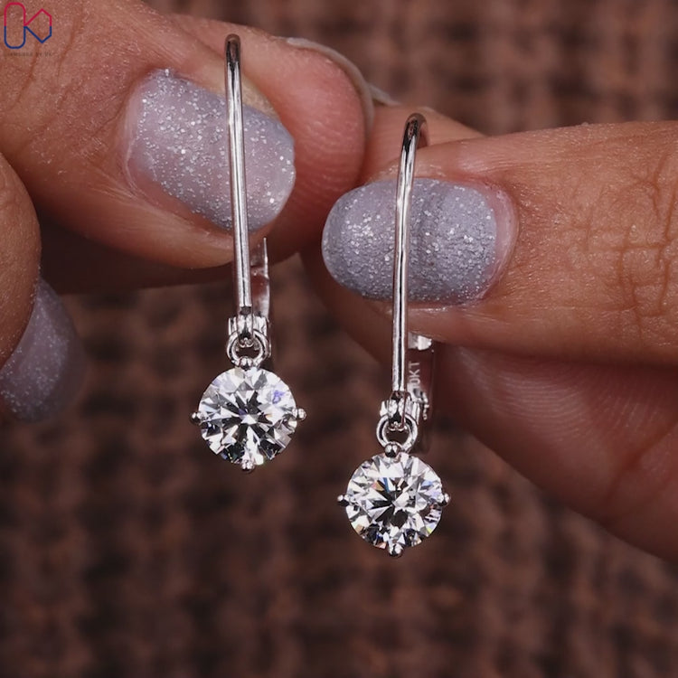 Round diamond earrings with dangle setting style.