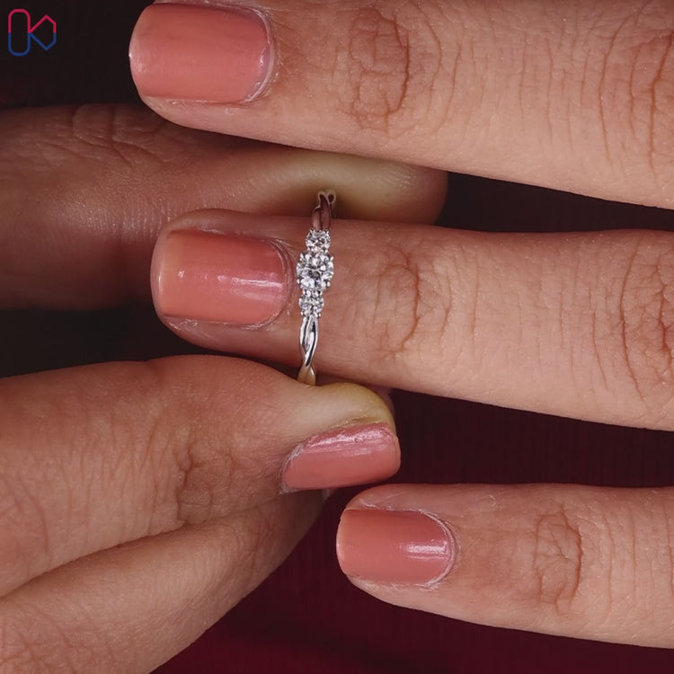 Elegant 3 stone engagement ring featuring a round diamond.
