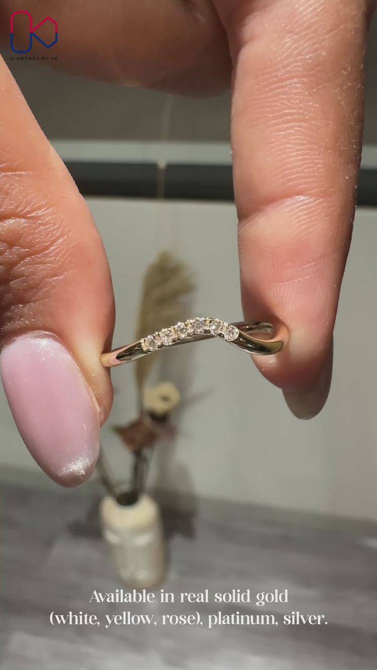 Round diamond wedding band with curved design.
