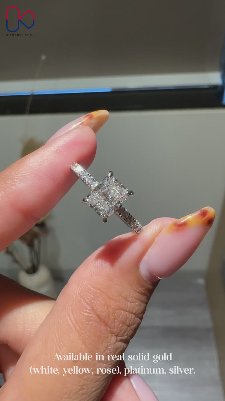 White gold ring with radiant and round cut diamonds.
