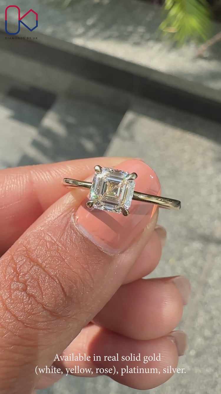 Yellow gold engagement ring with Asscher cut center stone.