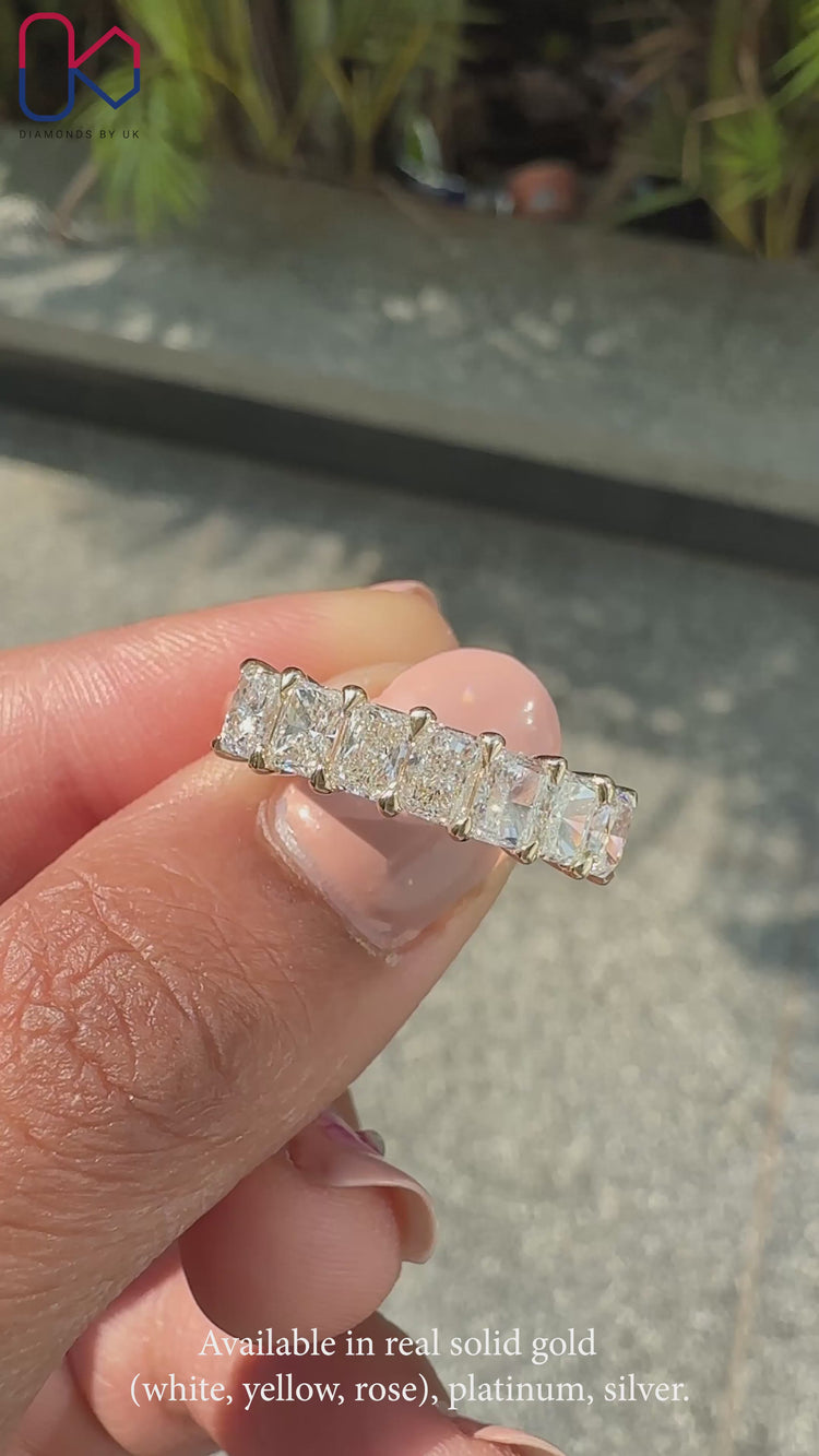Radiant diamond wedding band crafted with seven lab grown stones in a prong setting.
