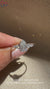 Round side stone pear cut engagement ring design.