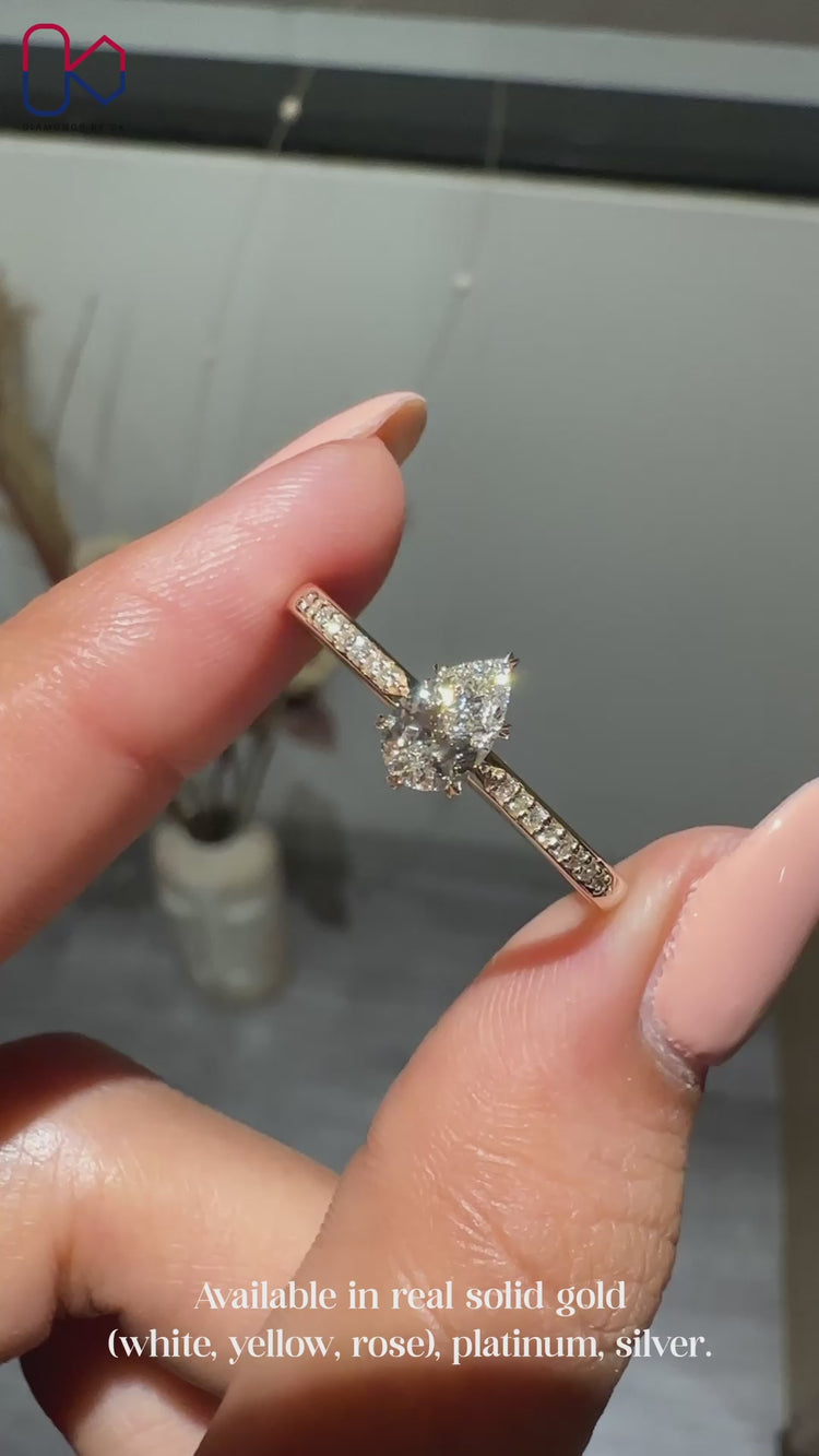 Pear cut ring with round diamond pavé setting.