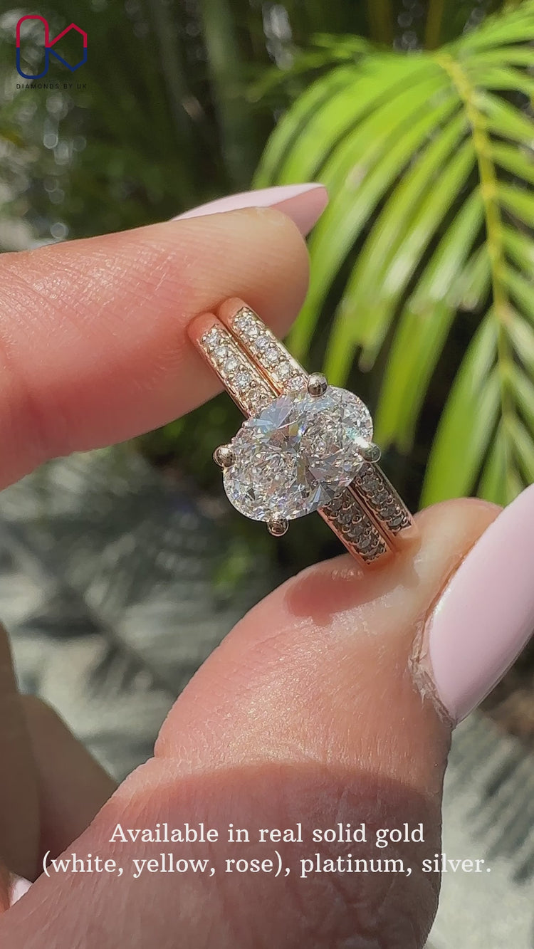 Oval shaped engagement ring with prong setting and hidden halo.

