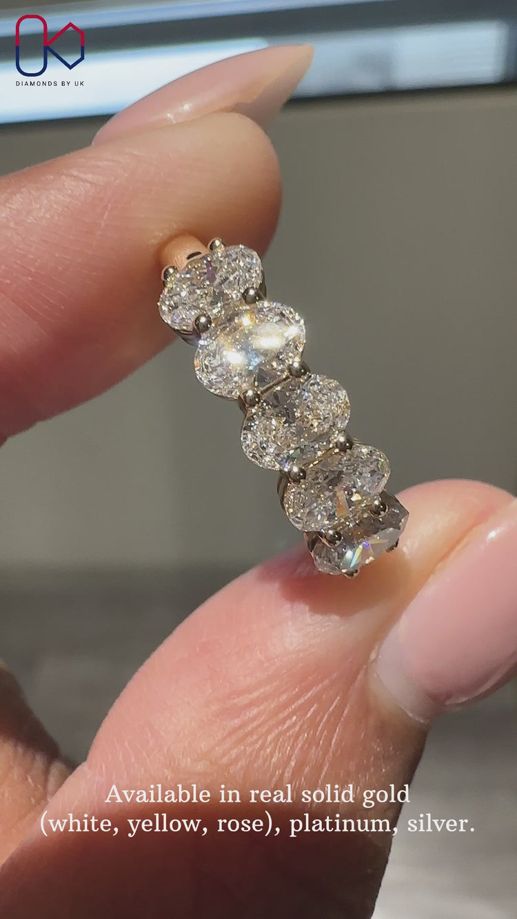 Oval diamond wedding band with five brilliant stones for added elegance.
