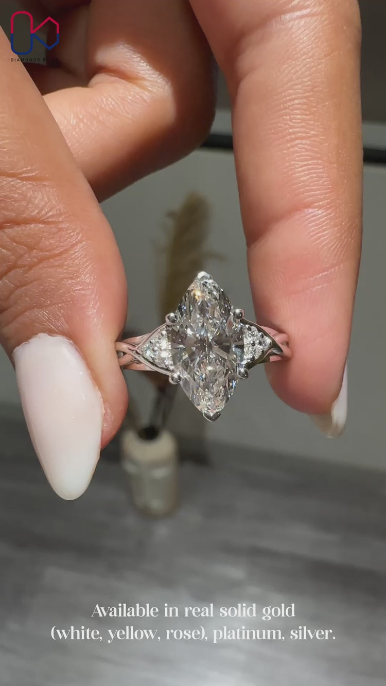 Cathedral marquise ring with round side stones.