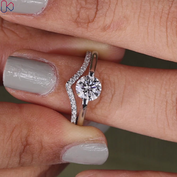 Round diamond ring with solitaire setting and curved wedding band.
