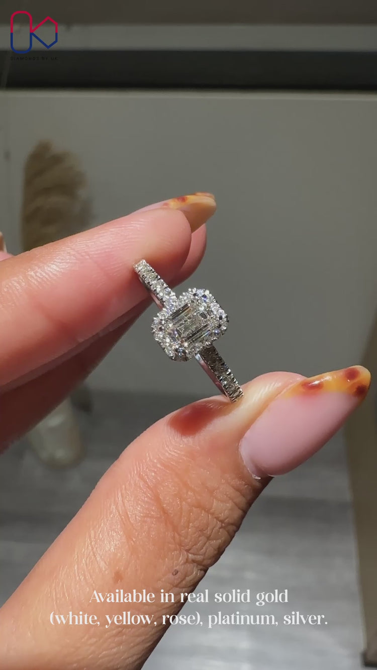Halo diamond ring with emerald cut centre stone.
