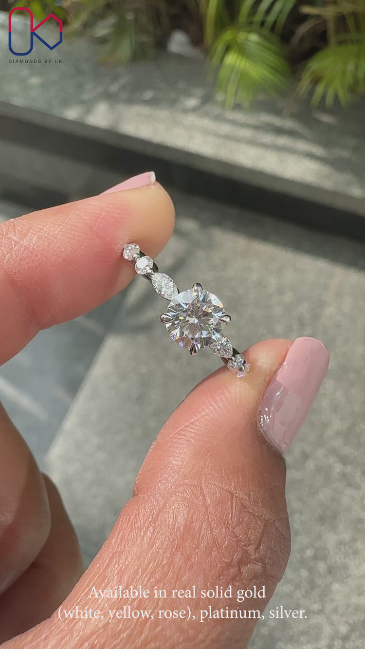 Marquise and round side stone ring in shared prong setting.
