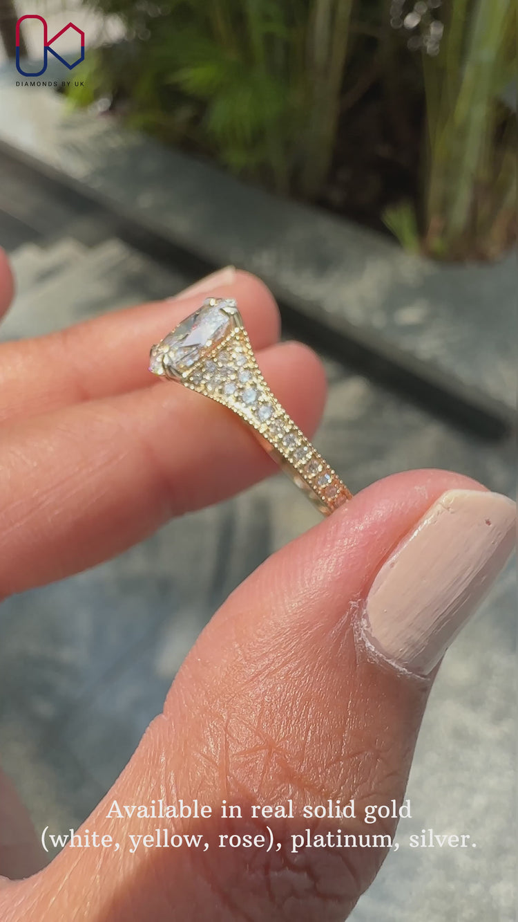 Oval diamond engagement ring in tapered pave setting.
