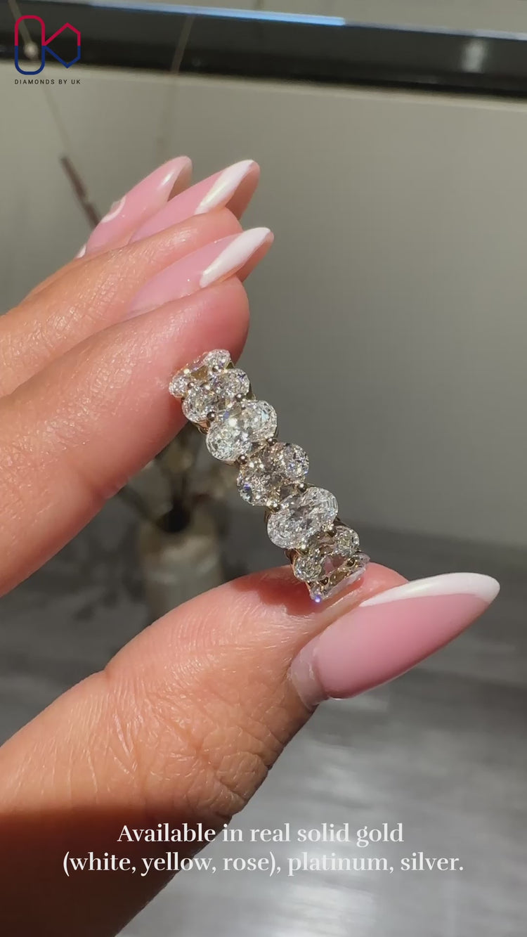 Half eternity diamond band with oval cut lab grown diamonds.
