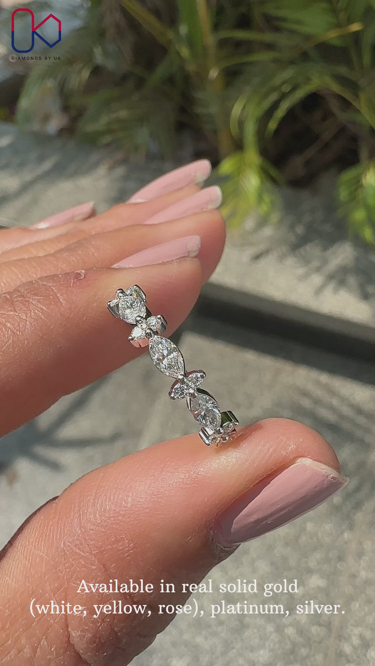 Marquise and round wedding band featuring a delicate prong set design.
