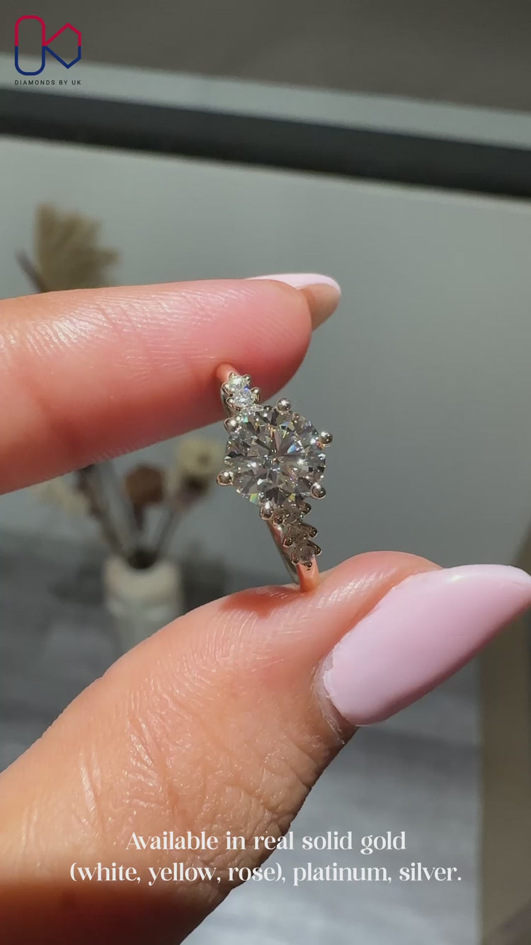 Muse setting round cut ring with side stones.