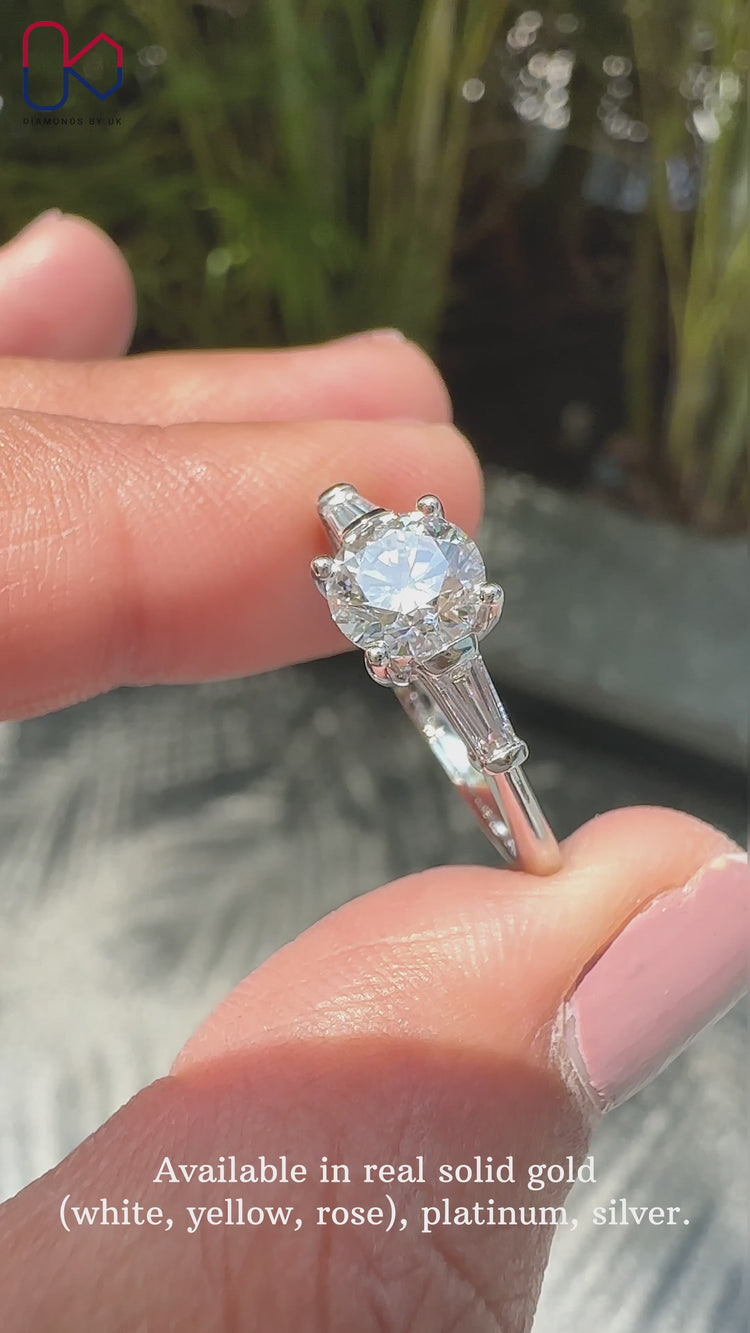 Round cut ring featuring a beautiful three stone engagement ring with diamonds.