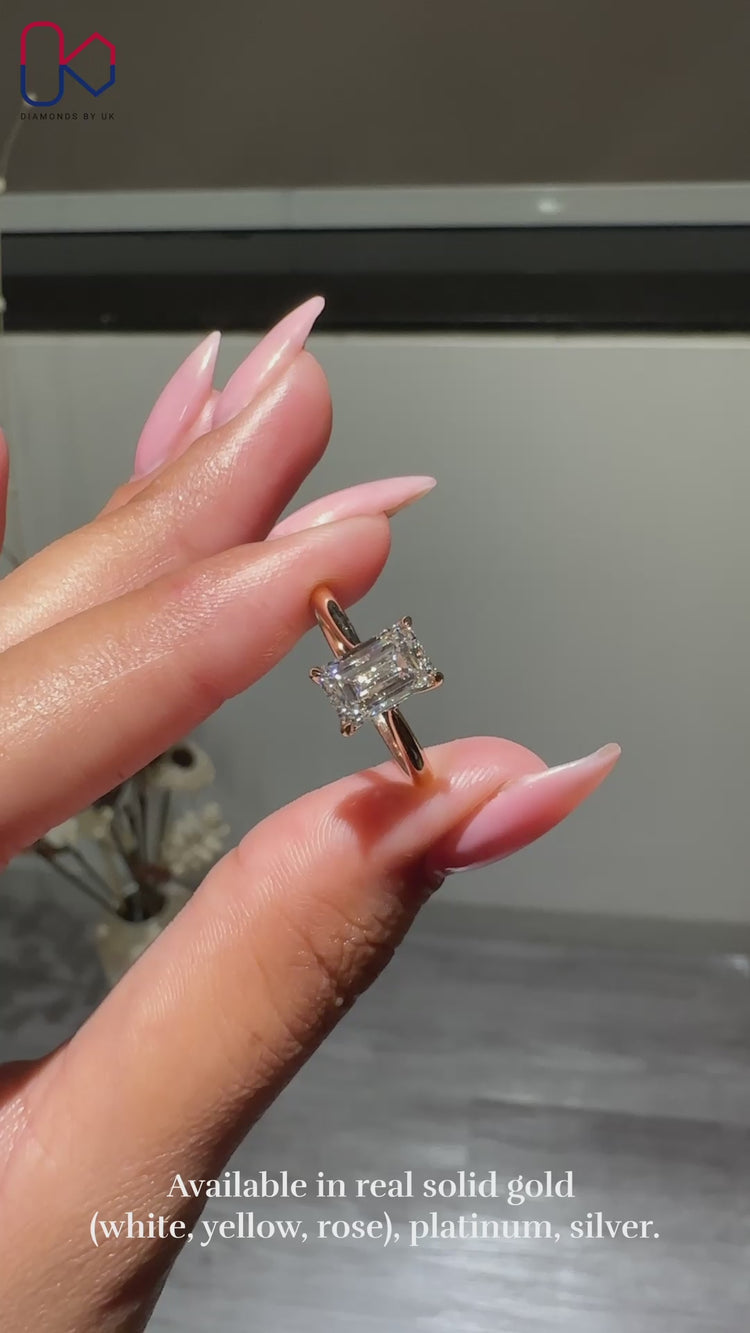 Emerald cut diamond ring with tapered shank.
