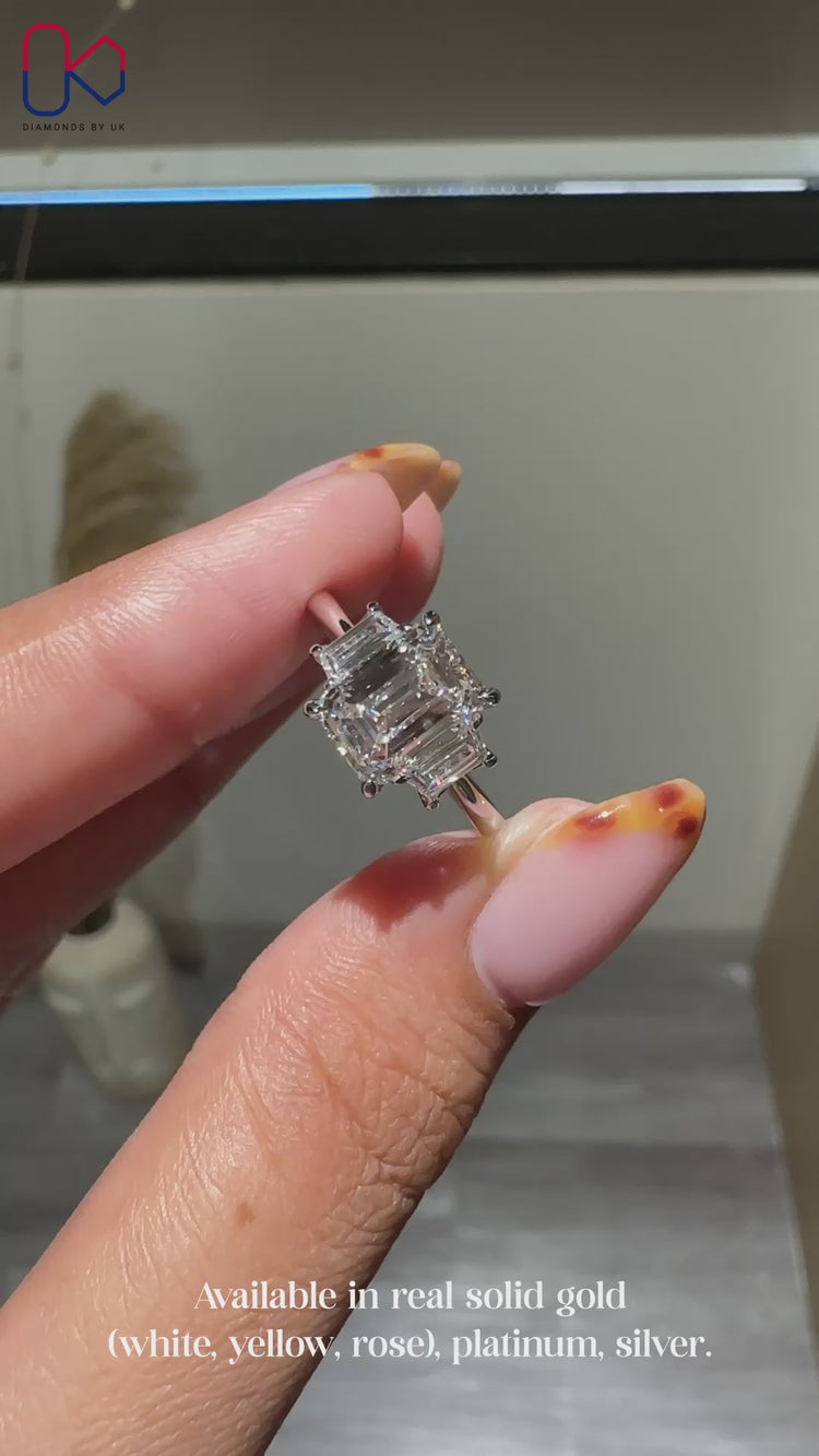 Emerald cut centre stone ring with baguette side accents.
