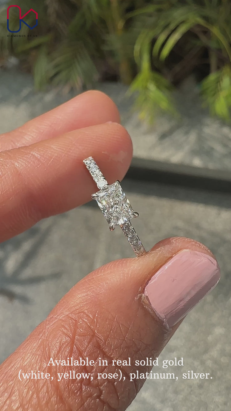 Radiant cut diamond ring in white gold with pave design.
