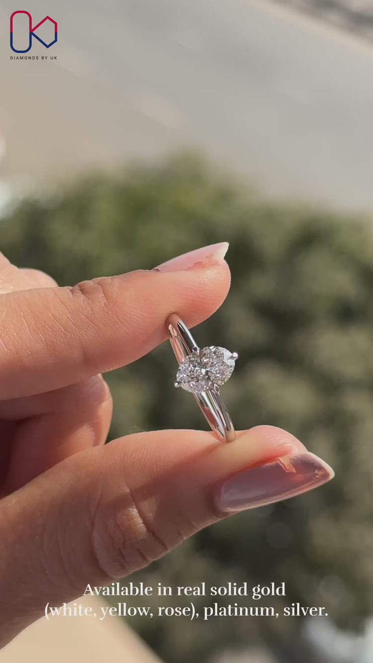 Oval solitaire engagement ring with white gold band.
