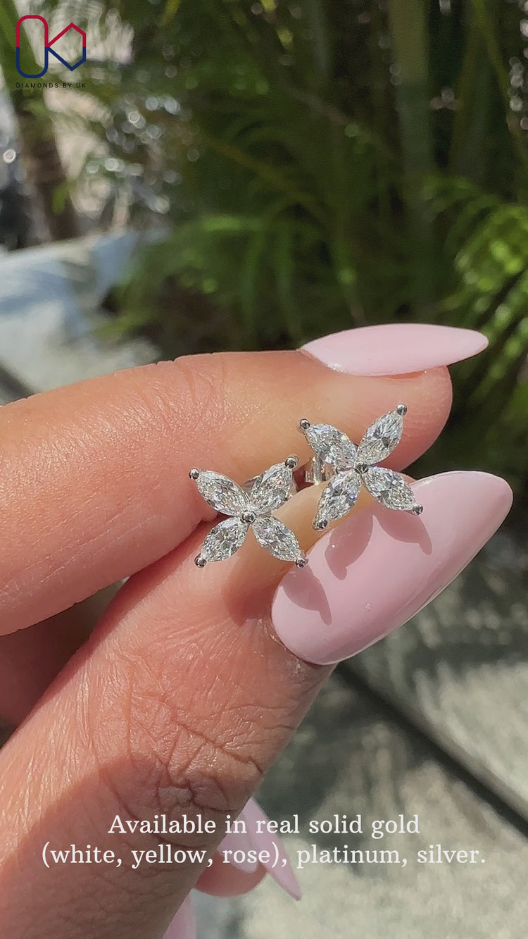 White gold earrings with prong set marquise diamonds.
