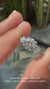 Elegant round diamond ring with pave diamond accents in white gold.