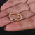 Round solitaire ring in a yellow gold setting.
