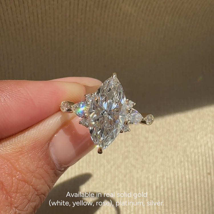 Marquise engagement ring with muse and claw prong setting.

