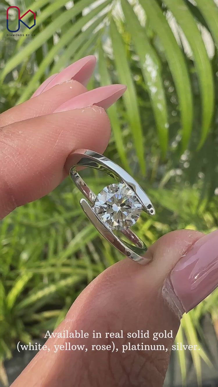 White gold round solitaire engagement ring by Diamondsbyuk.
