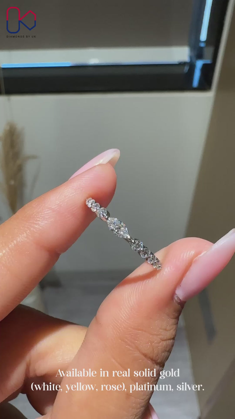 Half eternity wedding band with round and marquise diamonds.
