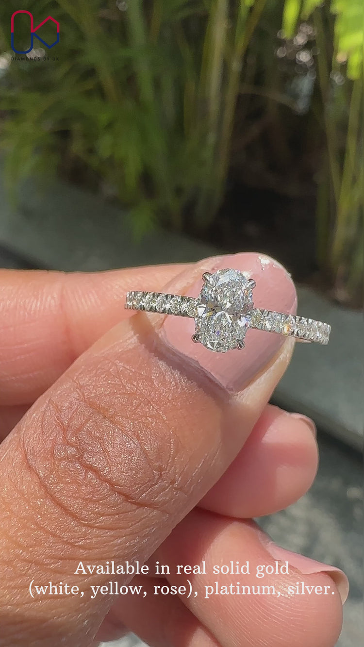 White gold ring with oval and round cut diamonds.