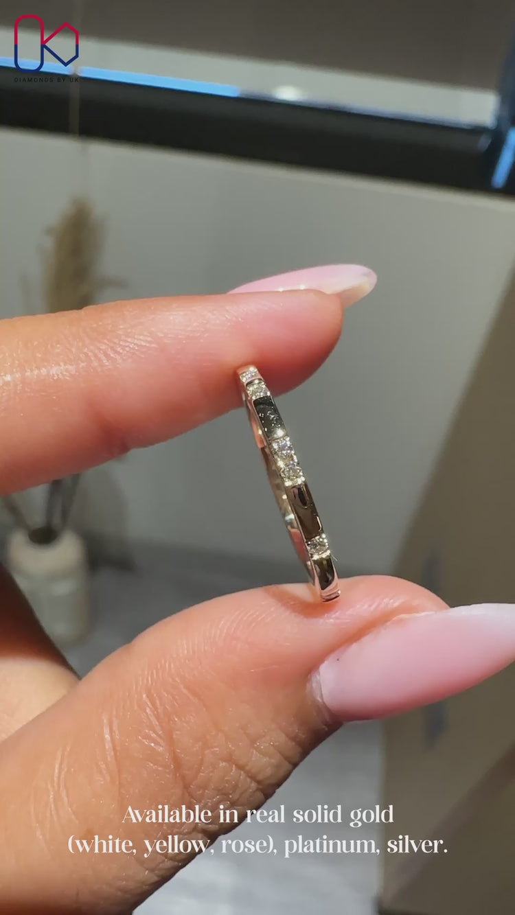 Yellow gold round diamond wedding band in distance pave design.
