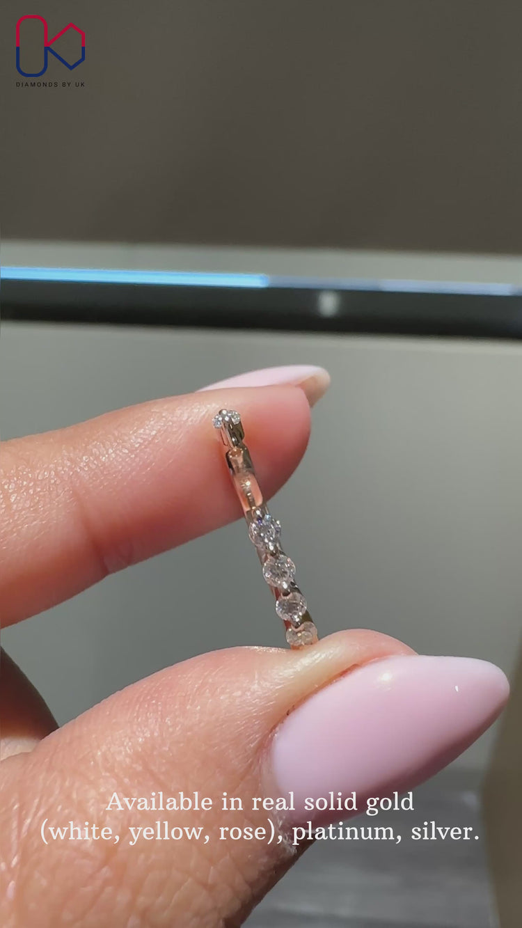 Shared prong diamond band in rose gold.
