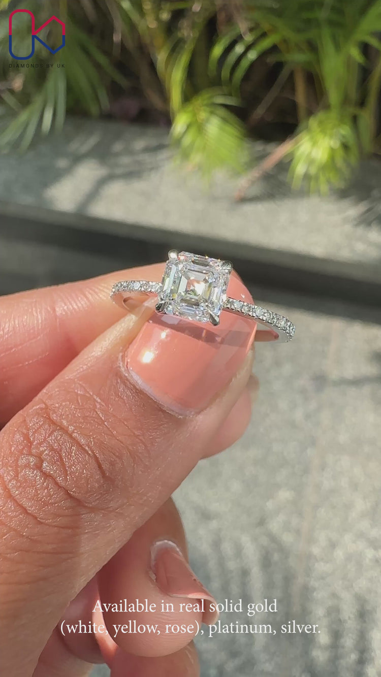 White gold engagement ring with Asscher and round diamonds.