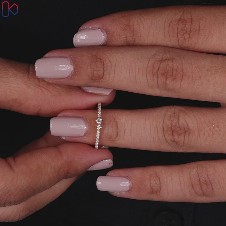 Round cut diamond band featuring prong set stones.

