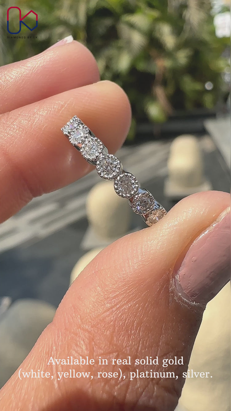 Bezel set wedding band showcasing securely placed sparkling diamonds.
