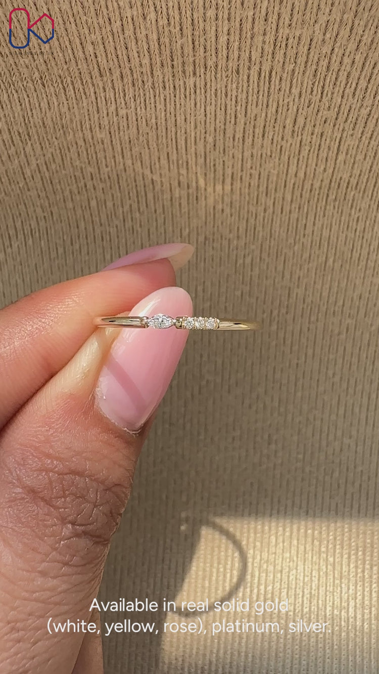 Four diamond wedding band crafted with marquise and round cuts in a prong setting.

