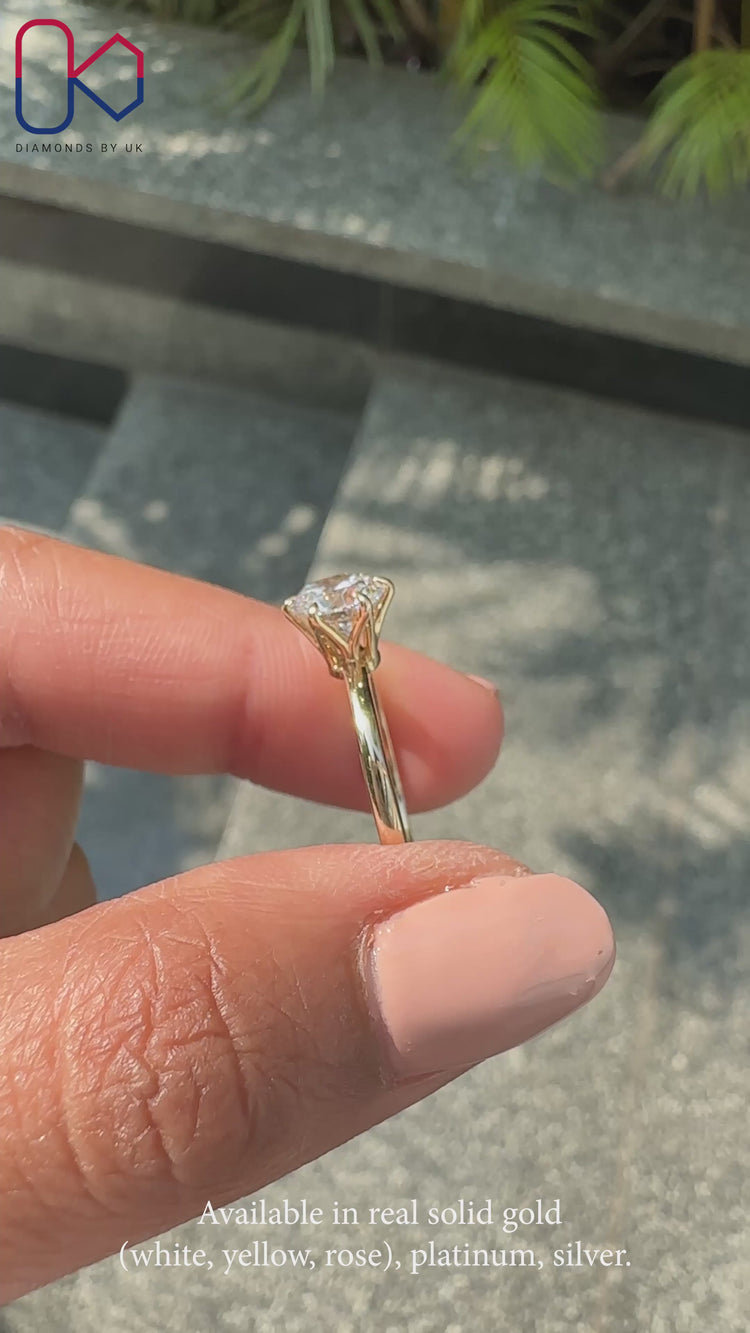 Round diamond engagement ring and yellow gold ring.
