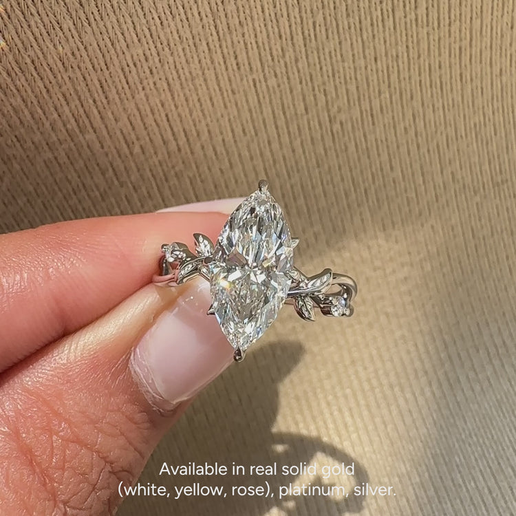 Marquise diamond ring with milgrain and cathedral setting.
