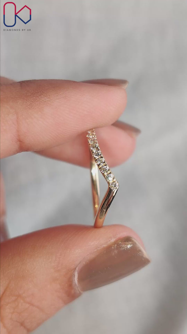 Chevron wedding band with round diamonds and V shape.
