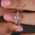 Engagement ring with oval cut diamond and 4 claw prong setting.
