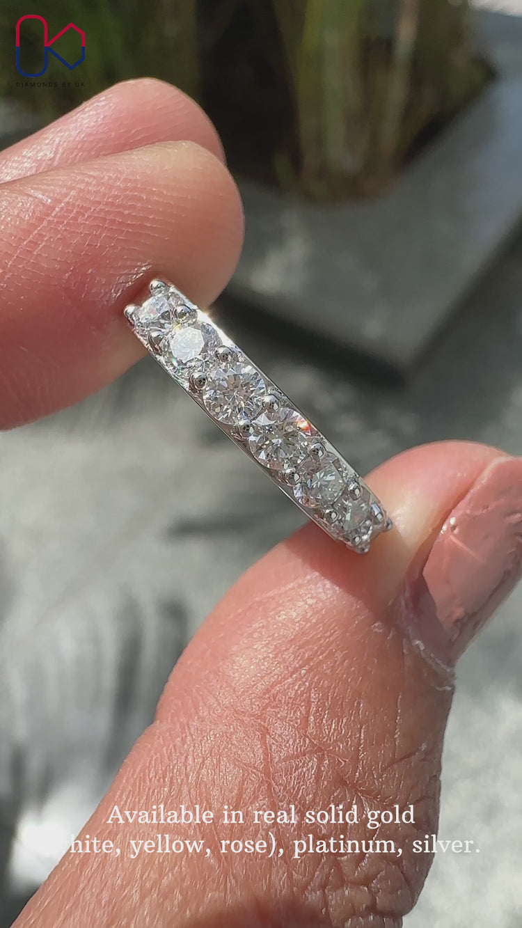 Round cut wedding band featuring lab grown diamonds.
