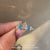 Marquise engagement ring with round aquamarine stones
