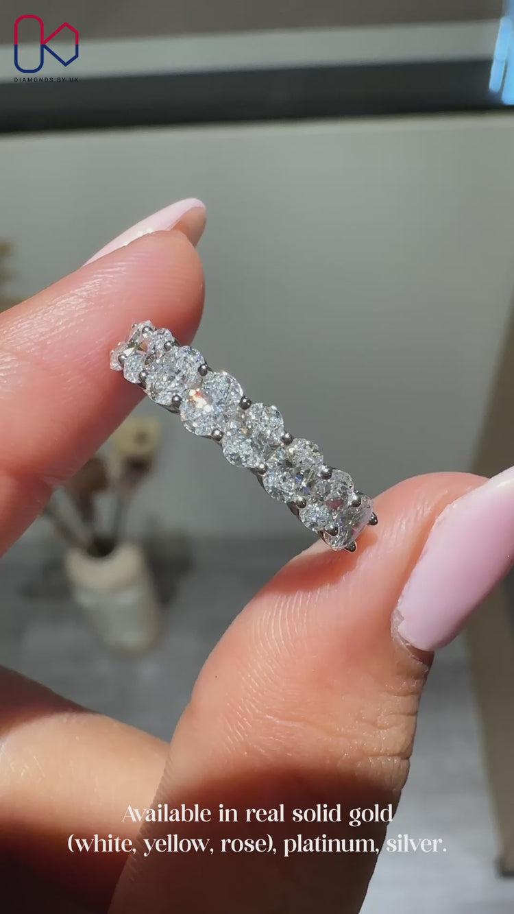 Half eternity wedding band with oval diamonds.
