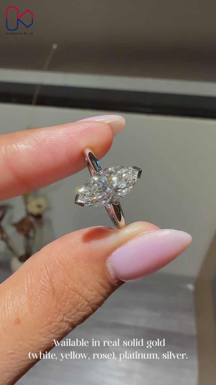 Solitaire setting ring featuring marquise cut diamond.
