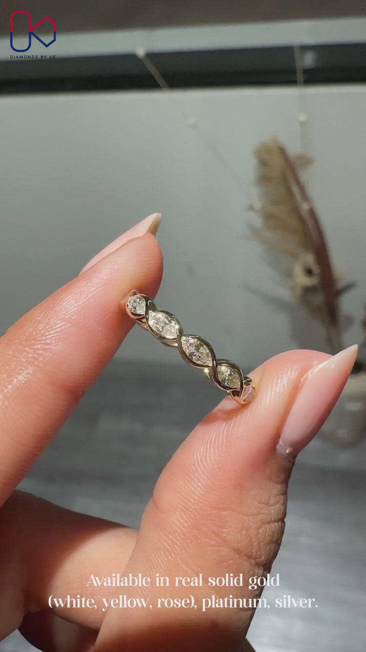 Bezel set wedding band with marquise diamonds.
