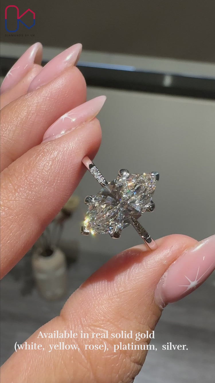 Marquise and Round Diamond Ring, featuring a tapered shank band and 4 prong claw setting in white gold for elegance.
