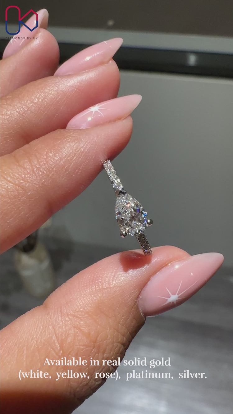 East to west setting ring featuring pear shaped center.
