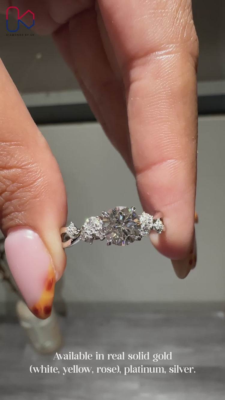 Nature inspired diamond engagement ring with round cut centre.
