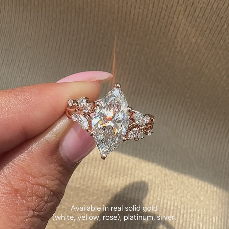 Nature inspired marquise ring with cluster side stones.
